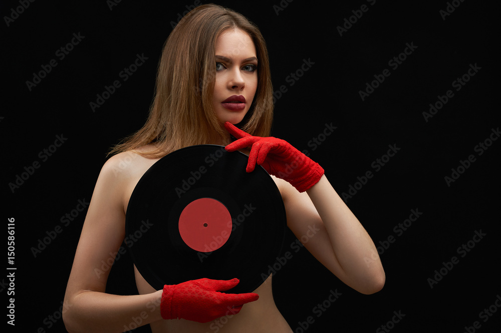 Hot Retro Nudes - Studio shot of a stunning beautiful young woman covering her naked body  with vinyl records posing sensually on black background copyspace nude sexy  retro vintage music fashion stylish concept. Stock Photo |
