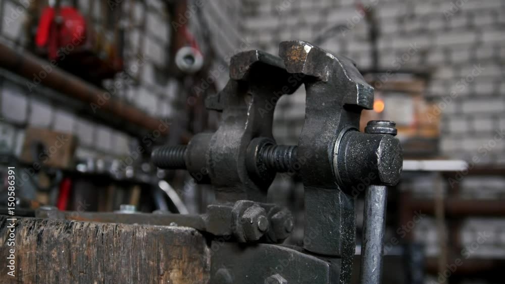 Inside forge workshop - steel vise, slider shot Inside forge workshop - steel vise, slider shot