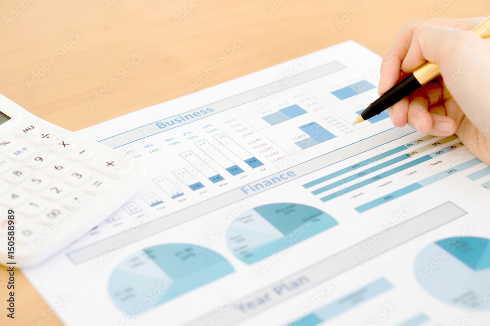 Businesswoman analyze year plan with calculator Businesswoman analyze year plan with calculator