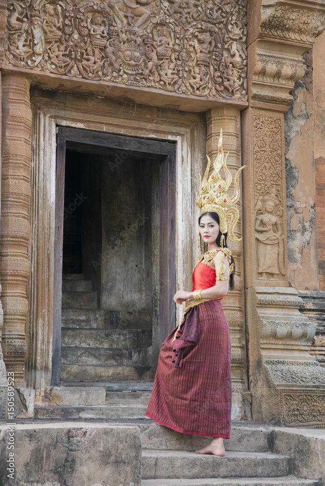 A beautiful woman in dancer apsara costume at stone castle,public place in Thailand