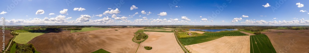 Aerial view 360 degree panorama of colorful agricultural fields in spring with blue sky - germany