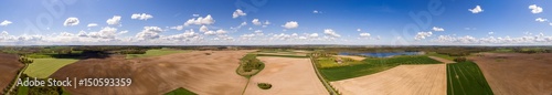Aerial view 360 degree panorama of colorful agricultural fields in spring with blue sky - germany