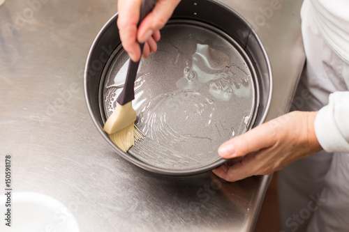 cook preparing mold for cooking photo