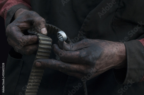 The worker's hands in oil