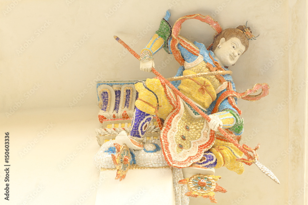 Fototapeta premium Statue of Nezha, Chinese demi god with mosaic or stucco tiles installed under the church roof at Wat Pariwat Temple, Bangkok, Thailand