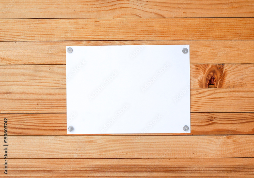 Empty paper ad loose leaves on a wooden wall. Attached metal buttons. Blank advertisement with cut slips Empty paper ad loose leaves on a wooden wall. Attached metal buttons. Blank advertisement with cut slips