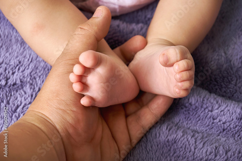 Tiny feet baby in mother hand closeup.concept love of family.Happy Family concept