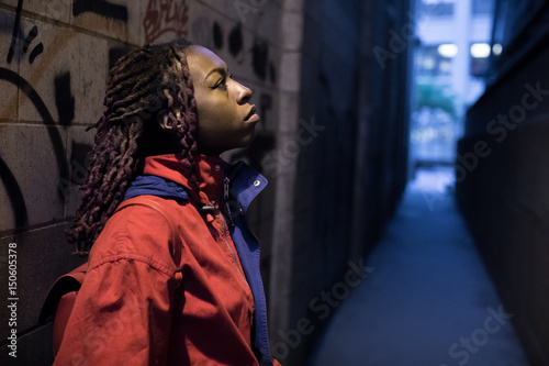 A portrait of a young, black woman with her skateboard in a Brooklyn alley. Shot using natural light during the Spring of 2017.