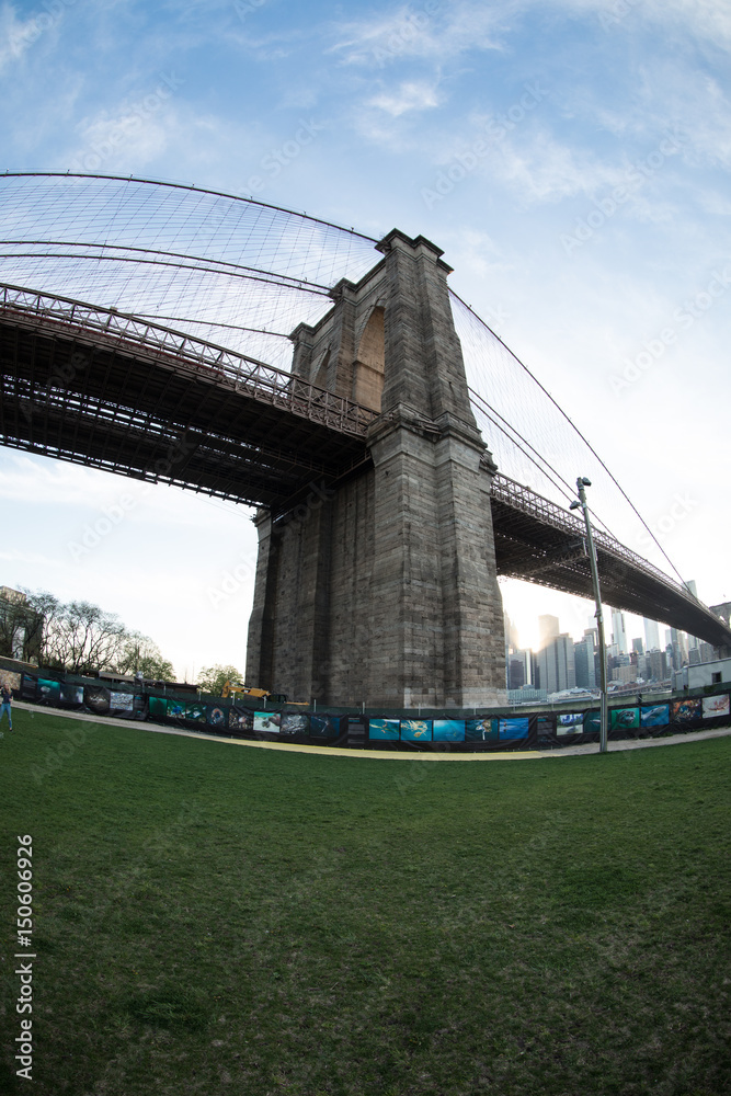 Fototapeta premium wide angle shot of New York City's Brooklyn Bridge on a Sunny Spring Day. Shot with a fisheye lens in DUMBO, Brooklyn.