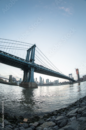 Fototapeta Naklejka Na Ścianę i Meble -  An iconic shot of New York City's Manhattan Bridge - DUMBO, Brooklyn. Shot from the Cobblestone of Washington Street during the Spring of 2017 with a Fisheye Lens.