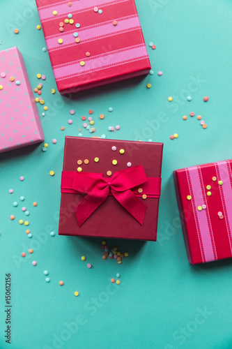 Holidays red and penk giftboxes on the pastel mint background for mother's day, christmas, birthday photo