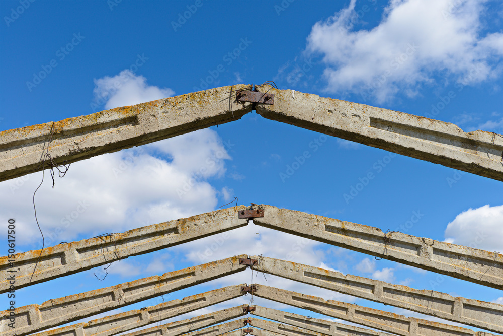 Skeleton of an old abandoned building against a blue sky