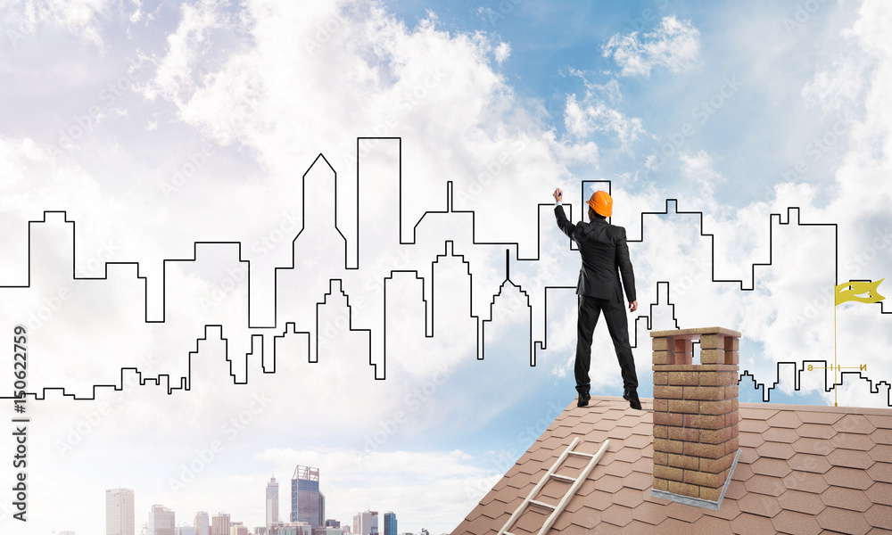 Man architect draw silhouette of modern city on blue sky. Mixed media Man architect draw silhouette of modern city on blue sky. Mixed media