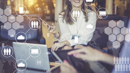 One-on-one meeting.Women have smartphone and digital tablet in their hands. Virtual icons with clouds,people,gadgets.
