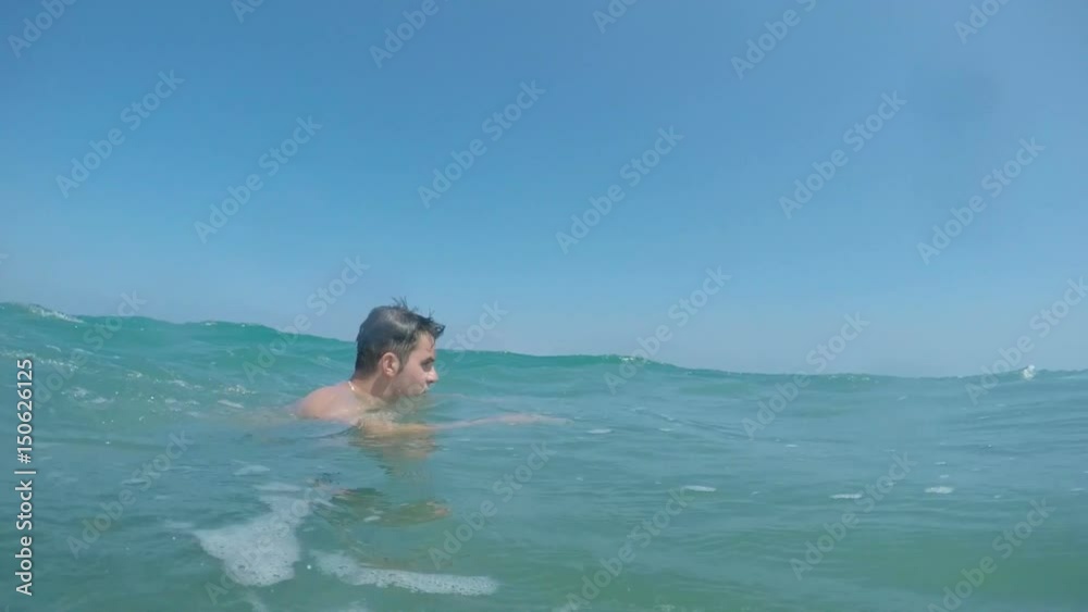 Slow-motion of a man swimming front crawl in the waves of heavy Alboran Sea in Andalusia, Spain. Slow-motion of a man swimming front crawl in the waves of heavy Alboran Sea in Andalusia, Spain.