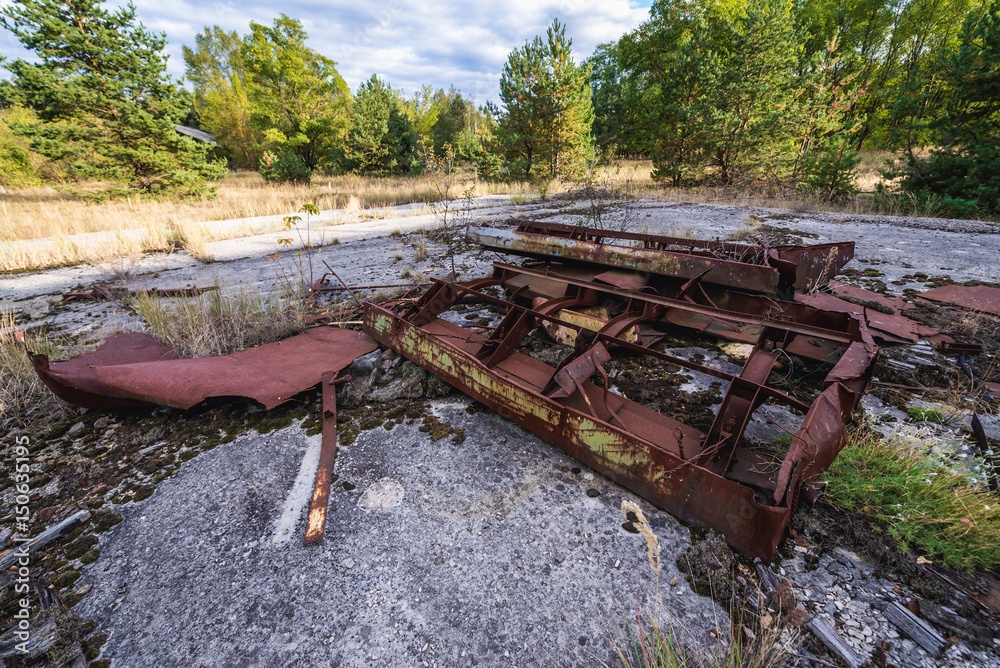 Destroyed machine in kolkhoz near Zymovyshche ghost village in Chernobyl Exclusion Zone, Ukraine Destroyed machine in kolkhoz near Zymovyshche ghost village in Chernobyl Exclusion Zone, Ukraine