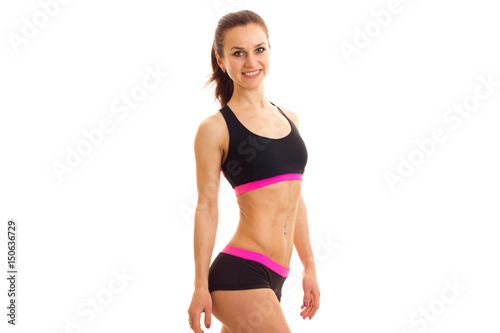 young slender girl in sportswear looks into the camera and smiling