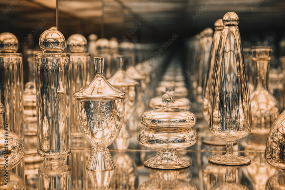 golden glass bottles reflected in the mirror.  recursive view