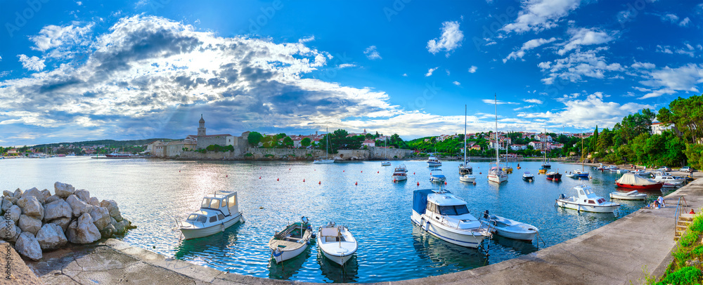Naklejka premium Wonderful romantic summer evening landscape panorama coastline Adriatic sea. Boats and yachts in harbor at cristal clear azure water. Old town of Krk on the island of Krk. Croatia. Europe.