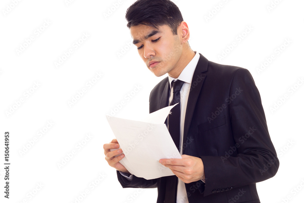 Young man in suit holding papers Young man in suit holding papers