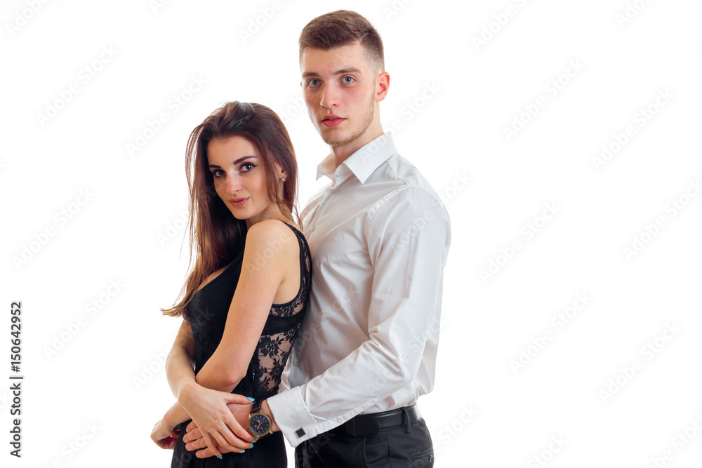 charming young couple hug each other and looking at camera