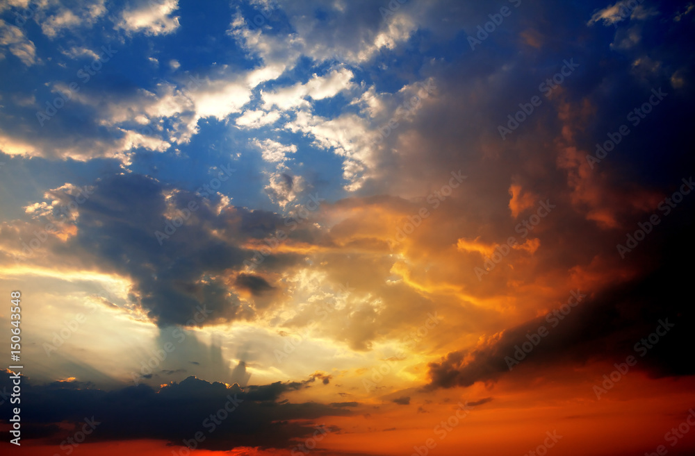 Multicolor sunset sky with clouds and sun rays