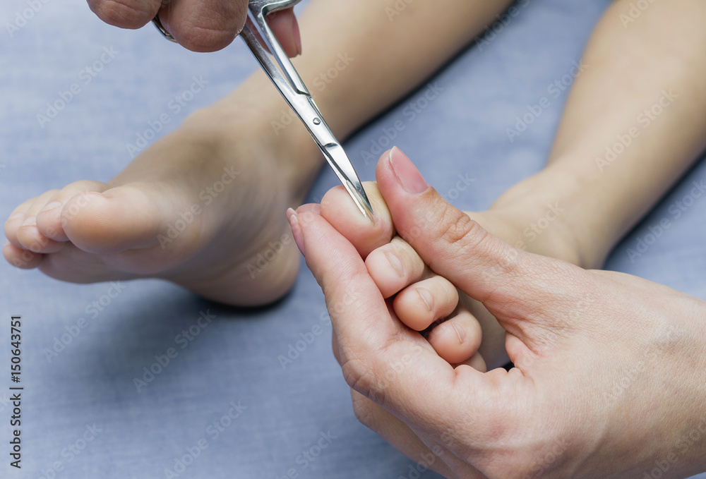 Pedicure for children. Mother cutting 4 year old baby's fingernails. Pedicure for children. Mother cutting 4 year old baby's fingernails.