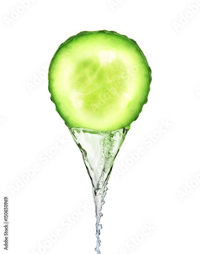 Essence flows as stream from fresh slice of cucumber on white background