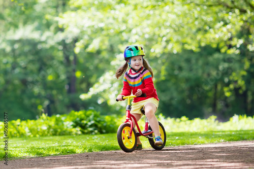 Fototapeta Naklejka Na Ścianę i Meble -  Kids ride balance bike in park
