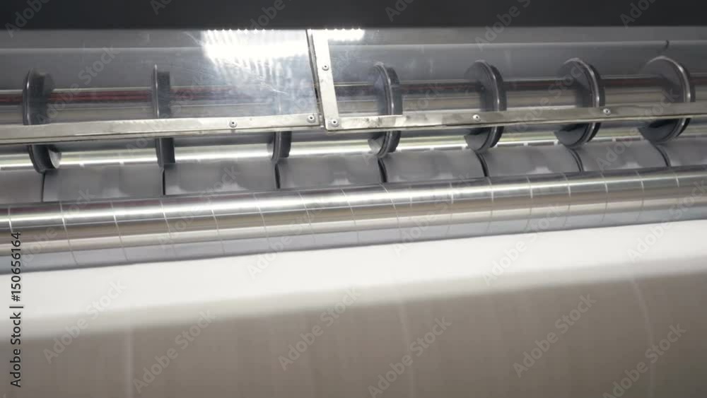 Industrial cutting machine working at napkins production line. 4K.