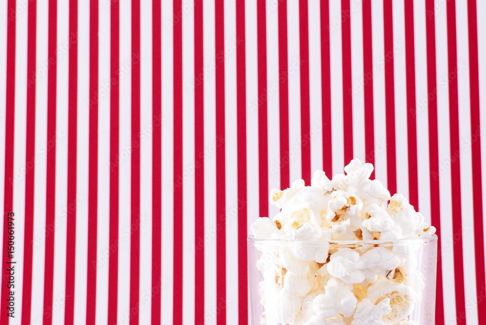 Popcorn in glass on a striped background Popcorn in glass on a striped background