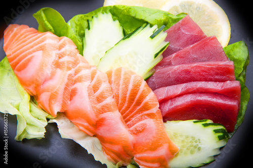 tuna and salmon sashimi on black dish
