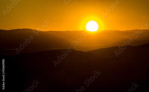 Glowing sunset behind mountainous landscape in Colorado © deberarr