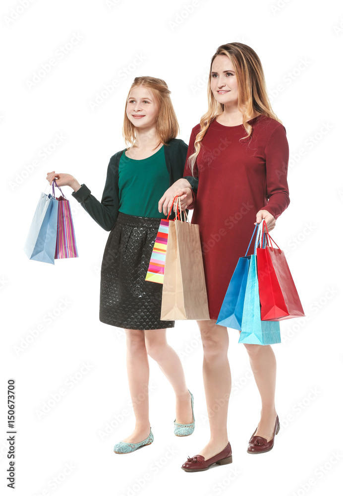 Mother and daughter with paper bags on white background Mother and daughter with paper bags on white background