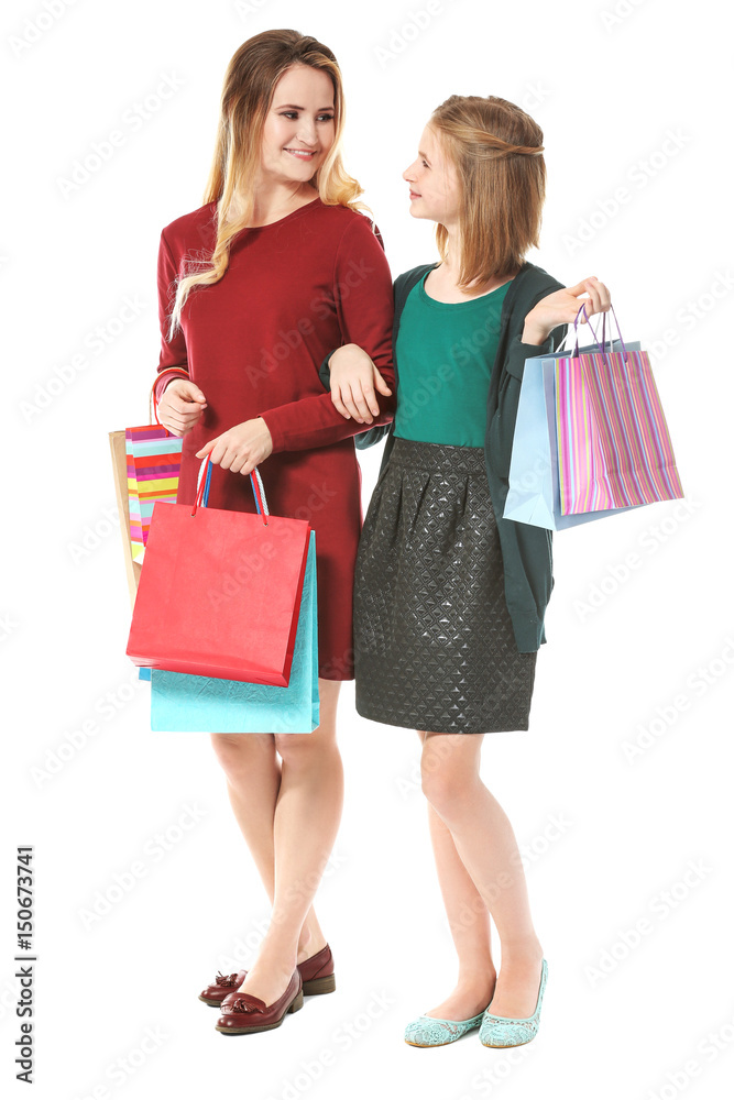 Mother and daughter with paper bags on white background Mother and daughter with paper bags on white background