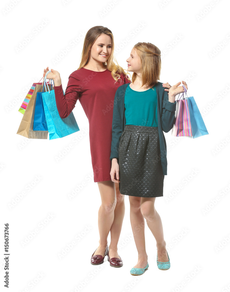 Mother and daughter with paper bags on white background