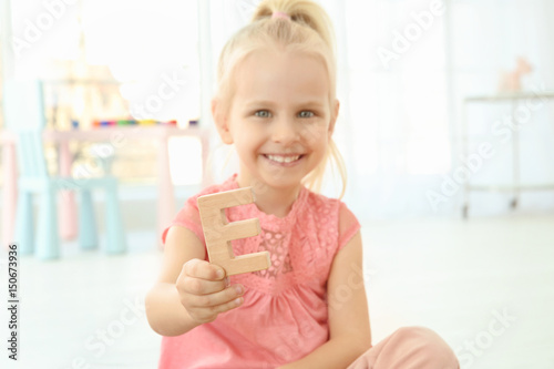 Cute little girl with lette...