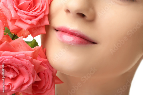 Face of beautiful young woman and roses  closeup