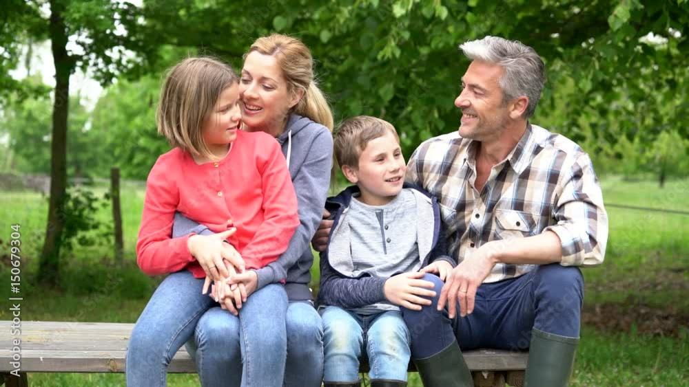 Portrait of happy family sitting on picnic table