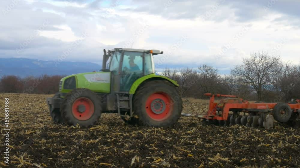 tractor cultivating ground of agro field at spring tractor cultivating ground of agro field at spring