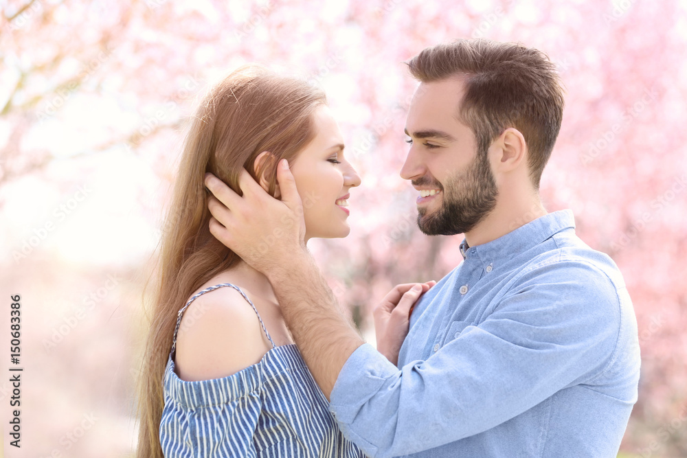 Young lovely couple walking in spring park