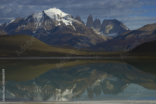 Peaks of Torres del Paine reflected in the still waters of Laguna Amarga in Torres del Paine National Park in southern Chile photo