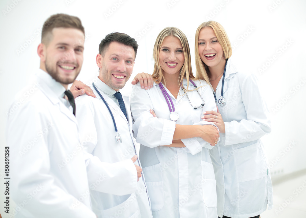 Happy and confident team of doctors posing on camera Happy and confident team of doctors posing on camera
