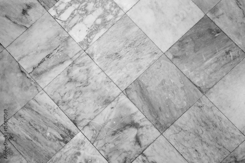 Close-up of a smooth marble floor with vignetting viewed from above in black&white.
