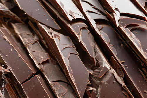 Close up of fine chocolate chopped by hand, sliced off the block with a knife.