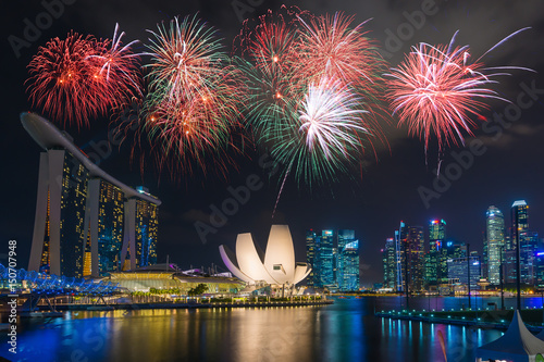 Singapore city skyline at night with beautiful night light with celebration fireworks. photo