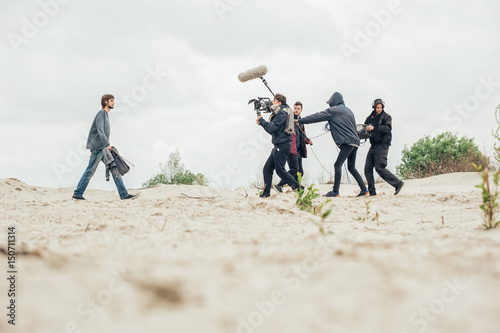 Fényképezés Behind the scene. Film crew filming movie scene outdoor