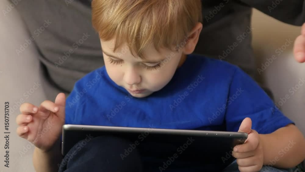 Father and Son using digital tablet together Father and Son using digital tablet together