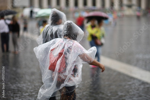 Photography A man and a woman in raincoats in the rain in St