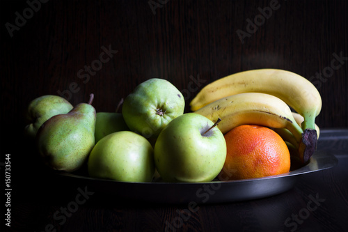 Fruits at the dark wooden kitchen